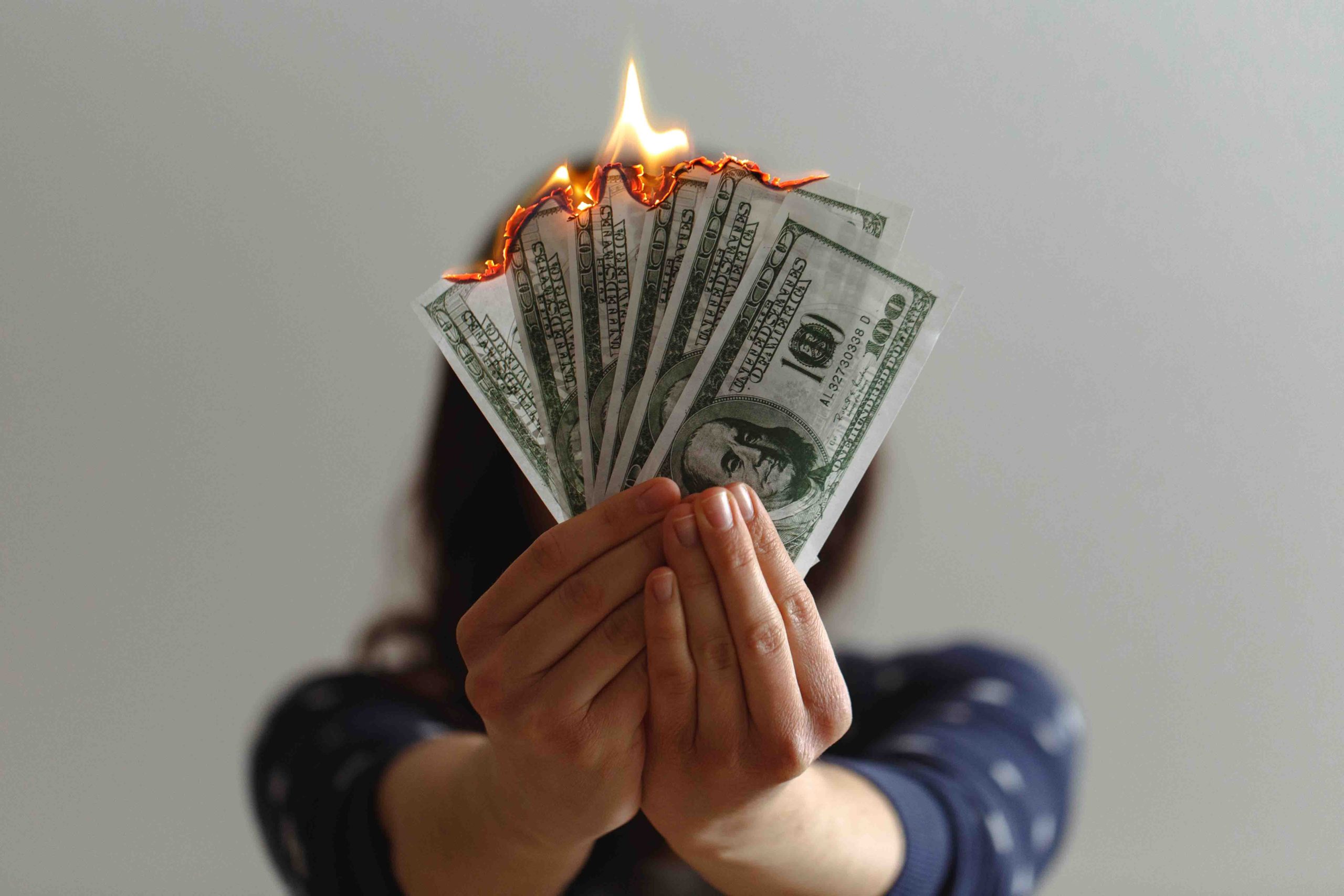Woman burning Dollar Bills